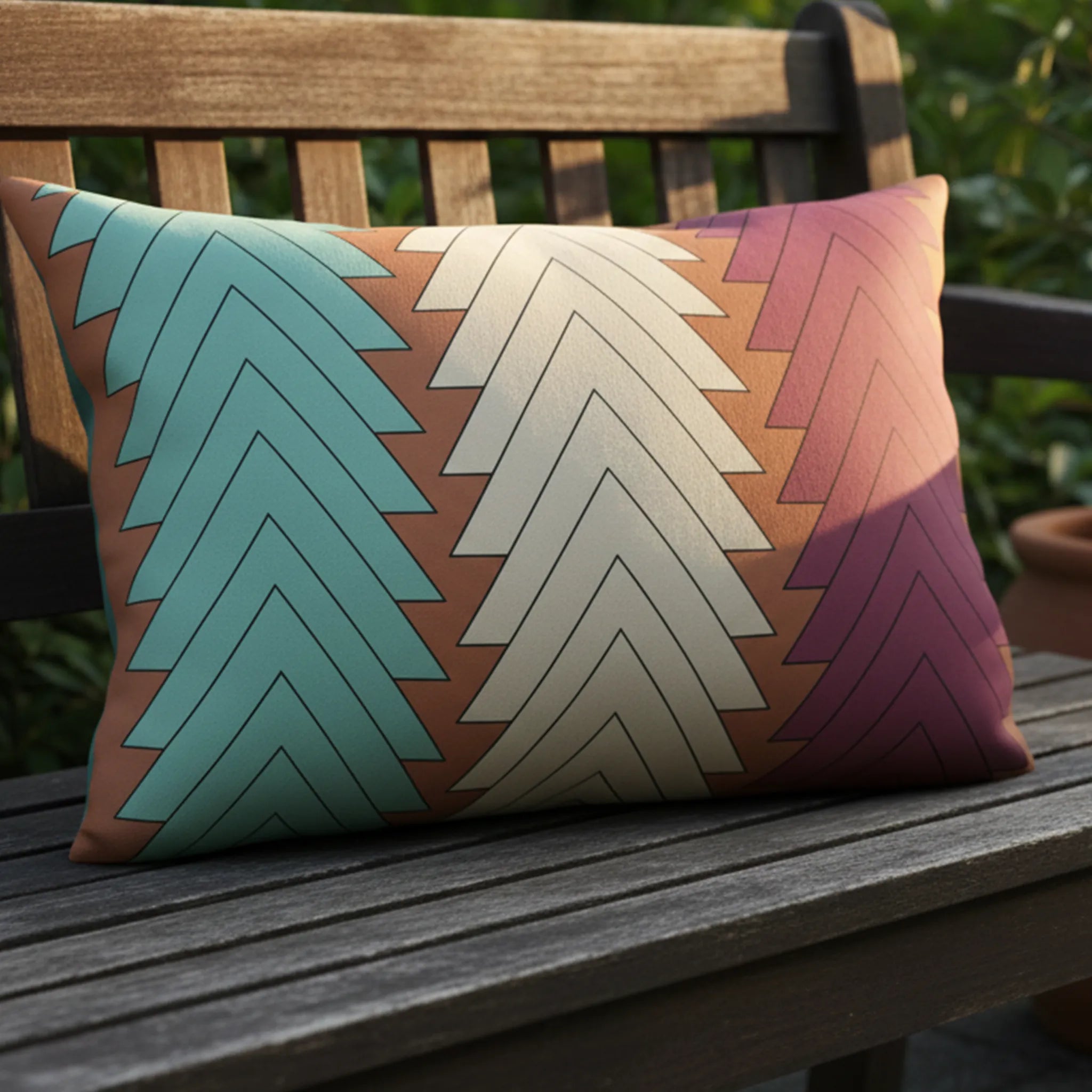 Boho chevron outdoor lumbar pillow on weathered bench, golden hour lifestyle, teal cream magenta terracotta.