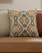 Tan leather sofa in a warm boho living room layered with a cream chunky knit pillow and woven wall art styled with the Multicolor Arrow Ikat Woven Pillow.