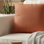 Boho Rust faux suede pillow case styled on a couch in a modern living room.