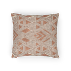 A horizontal view of the Boho Salmon Red Geometric Woven Pillow showing a salmon background and ivory ikat geometric patterns. 