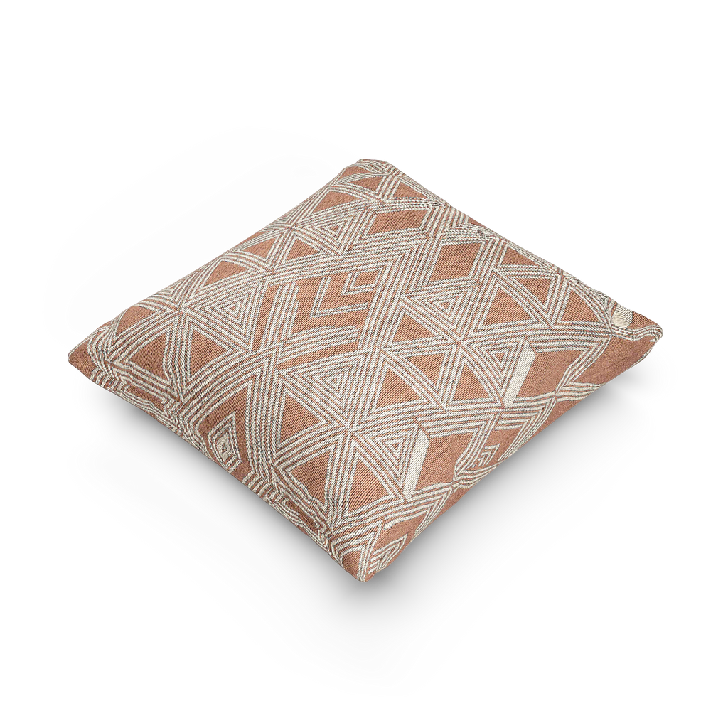 A side view of the Boho Salmon Red Geometric Woven Pillow showing a salmon background and ivory ikat geometric patterns. 