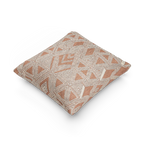 A side view of the Boho Salmon Red Geometric Woven Pillow showing a salmon background and ivory ikat geometric patterns. 