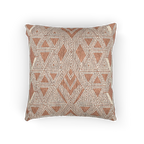 A front view of the Boho Salmon Red Geometric Woven Pillow showing a salmon background and ivory ikat geometric patterns. 