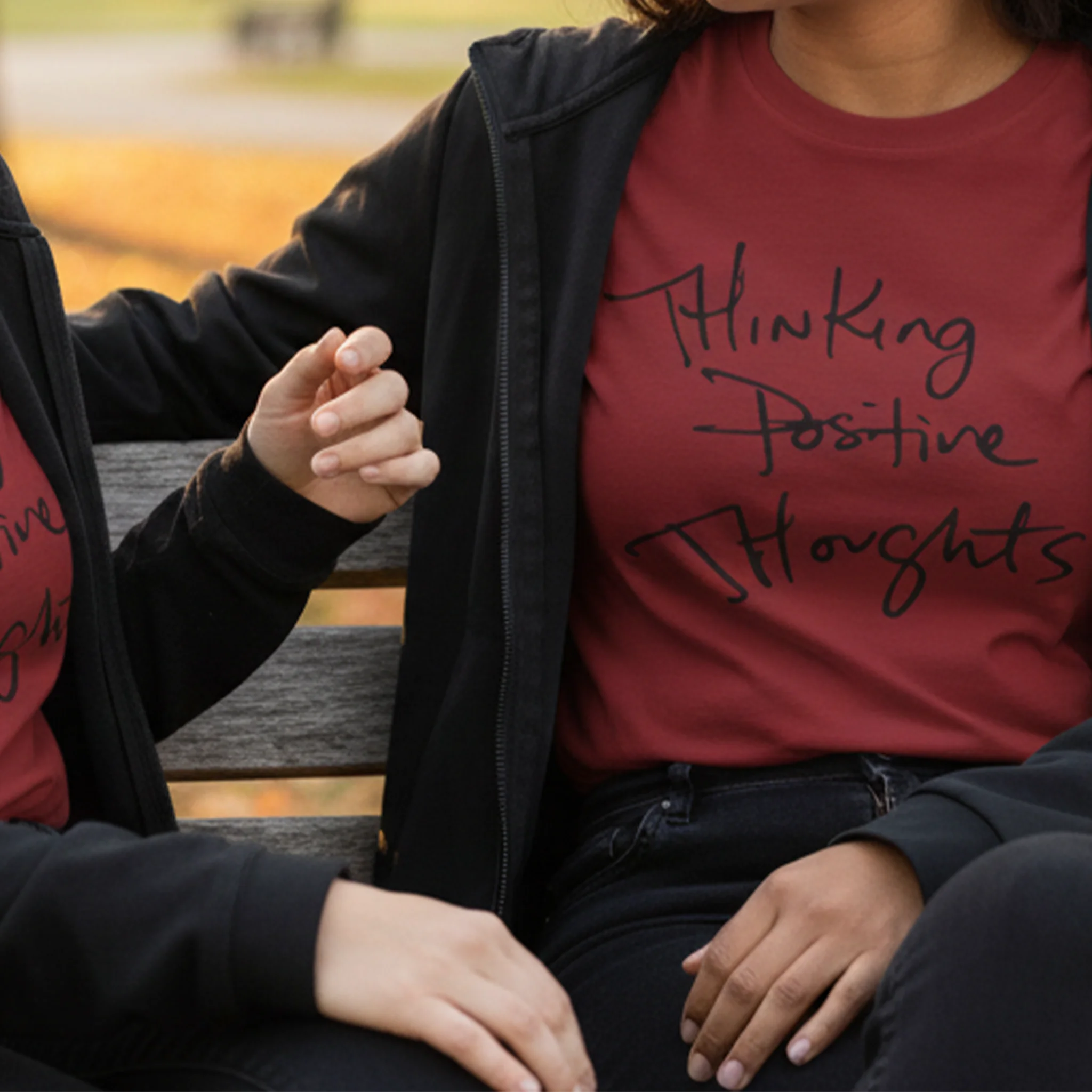 Cardinal Bella Thinking Positive Thoughts long sleeve tee styled with zip hoodie, park bench lifestyle front view.
