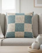 Light grey linen wingback sofa in a bright Nordic living room with white ceramic vases on a wood tray styled with the Danish Blue Cream Checkered Pillow.