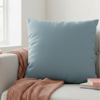 Danish Blue faux suede pillowcase styled on a couch in a modern living room.