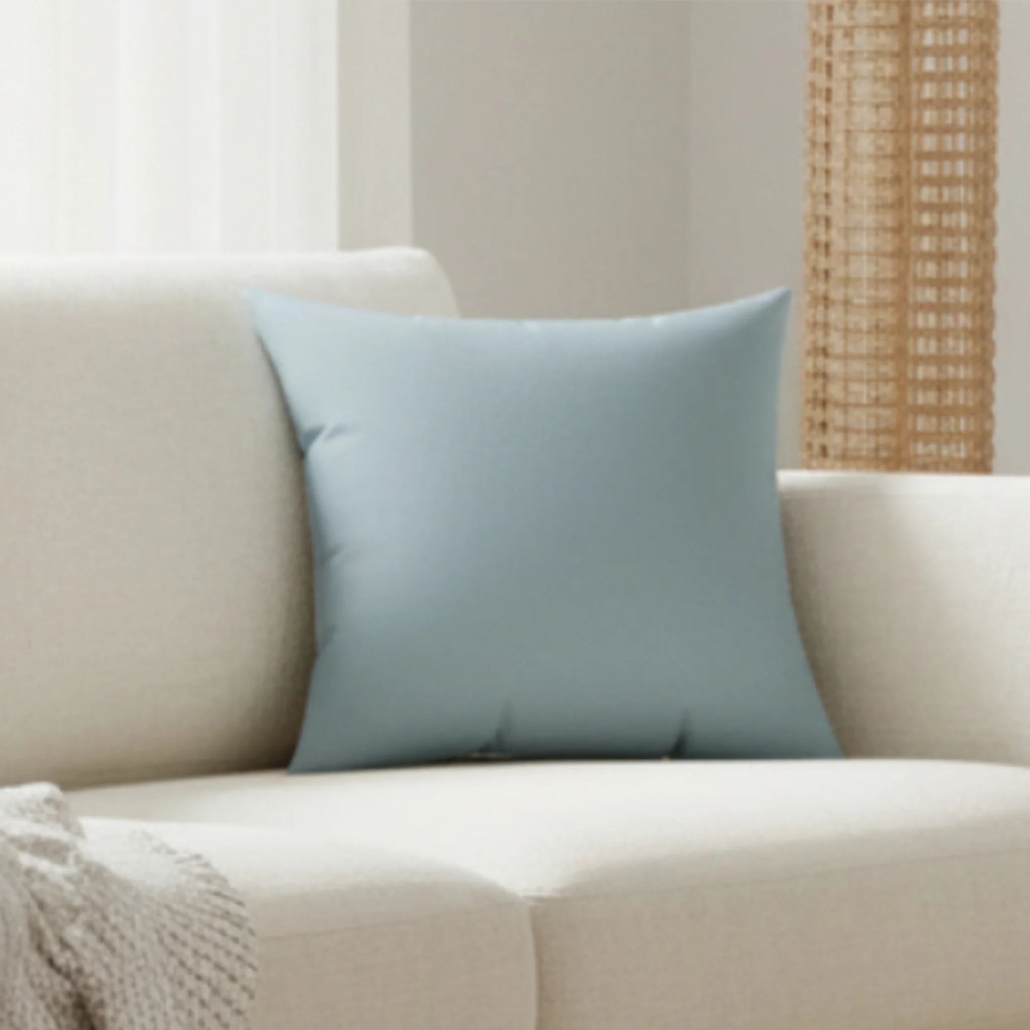 Danish blue faux suede throw pillow styled on a beige couch in a modern living room, lifestyle view.