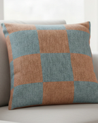 White fabric sofa in a bright airy living room with sheer curtains and natural window light styled with the Danish Blue Checkered Woven Pillow.