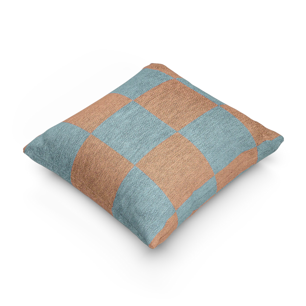 A side view of the Danish Blue Vintage Salmon Checker Woven Pillow showing danish blue checker squares on a salmon red background.