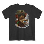 A dark grey heather t-shirt featuring the Good Boy Waterfowl graphic of a chocolate Labrador wearing sunglasses and a camo snapback, holding a mallard duck, with a watercolor outdoor scene and 'Good Boy Waterfowl' script below.