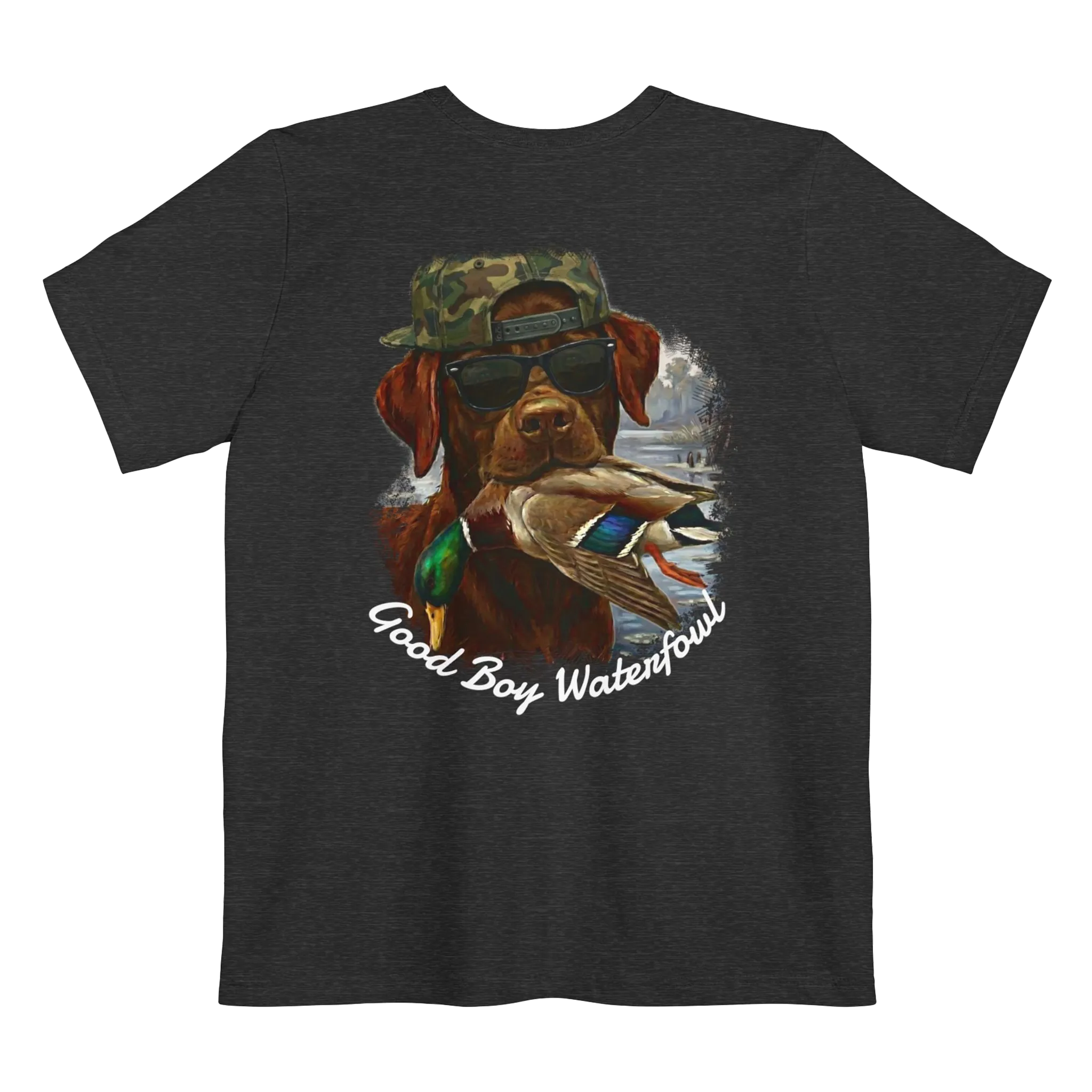 A dark grey heather t-shirt featuring the Good Boy Waterfowl graphic of a chocolate Labrador wearing sunglasses and a camo snapback, holding a mallard duck, with a watercolor outdoor scene and 'Good Boy Waterfowl' script below.