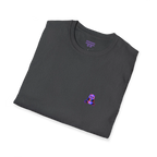 A folded view of the dark heather t-shirt featuring a small glitch art pixel panda holding a coffee cup with a chromatic aberration effect in purple, blue, and red on the left chest and a purple FREEBRD logo on the inner neck label. 
