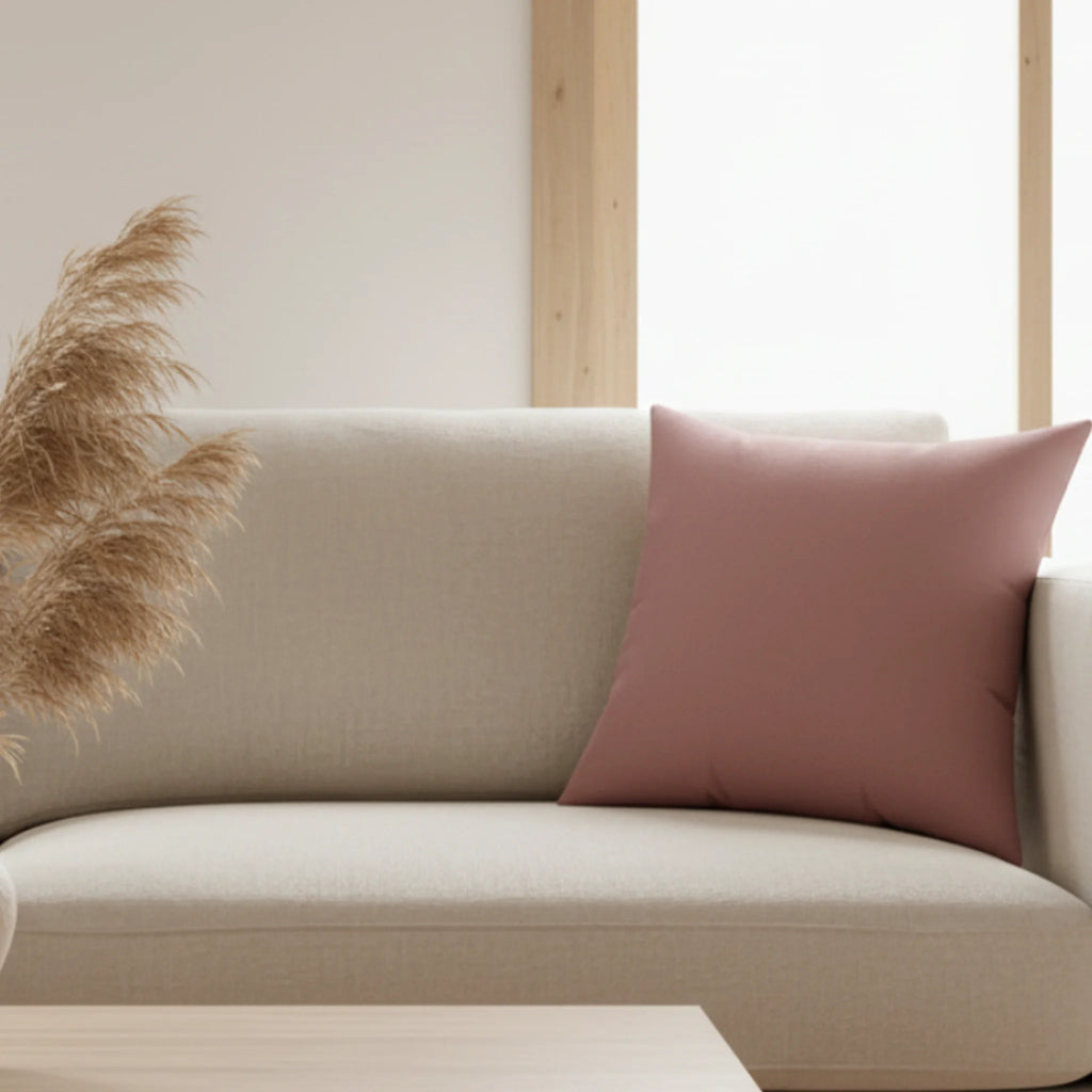 Dark old rose faux suede pillow, styled on a couch in a nordic living room, lifestyle view.