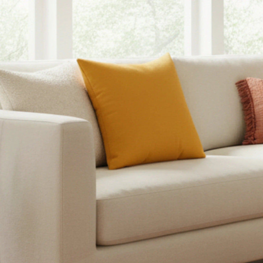 Dixie Florida orange faux suede throw pillow styled on a beige couch in a modern living room, lifestyle view.
