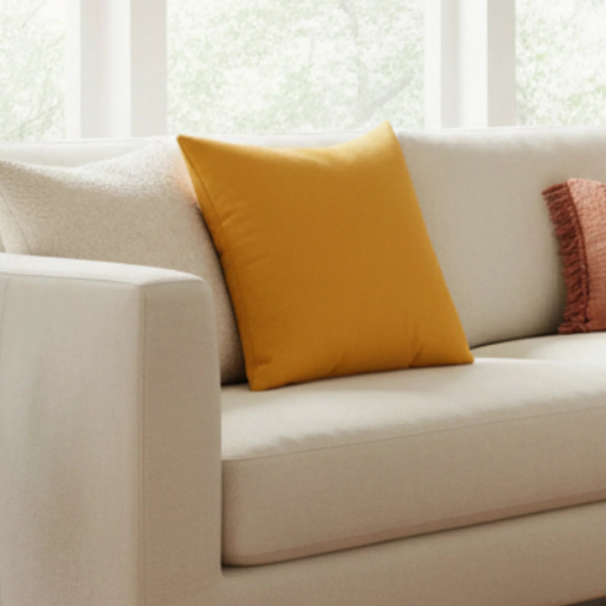 Dixie Florida orange faux suede throw pillow styled on a beige couch in a modern living room, lifestyle view.