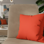 Dragon fire red faux suede pillow case styled on a modern sofa chair in a living room.
