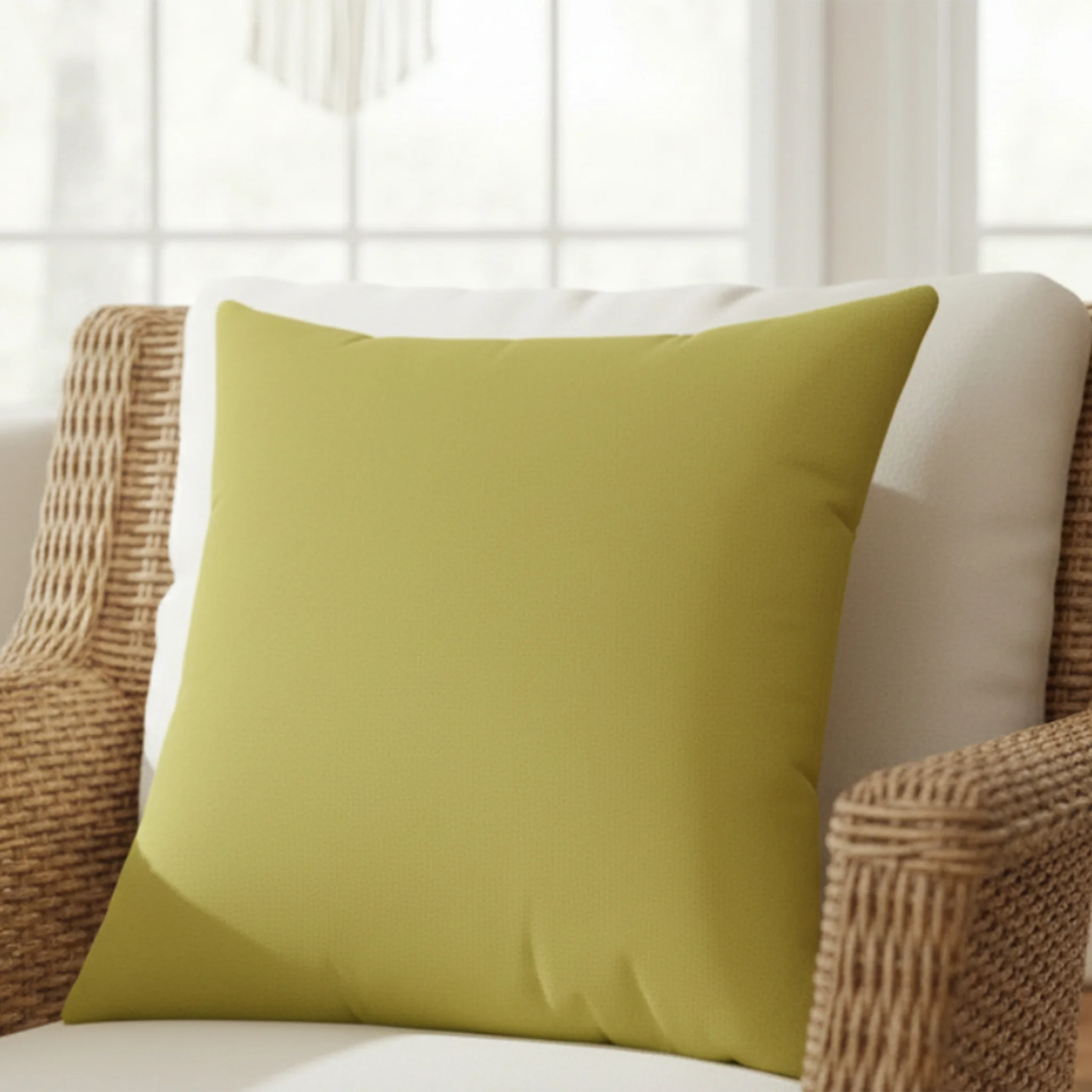 Dull gold yellow faux suede pillow styled on sofa, muted chartreuse mid-century home decor.