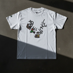 Graphic heart t-shirt with graffiti-style "End the Violence" mixed-media art, white, flat lay on dark concrete surface
