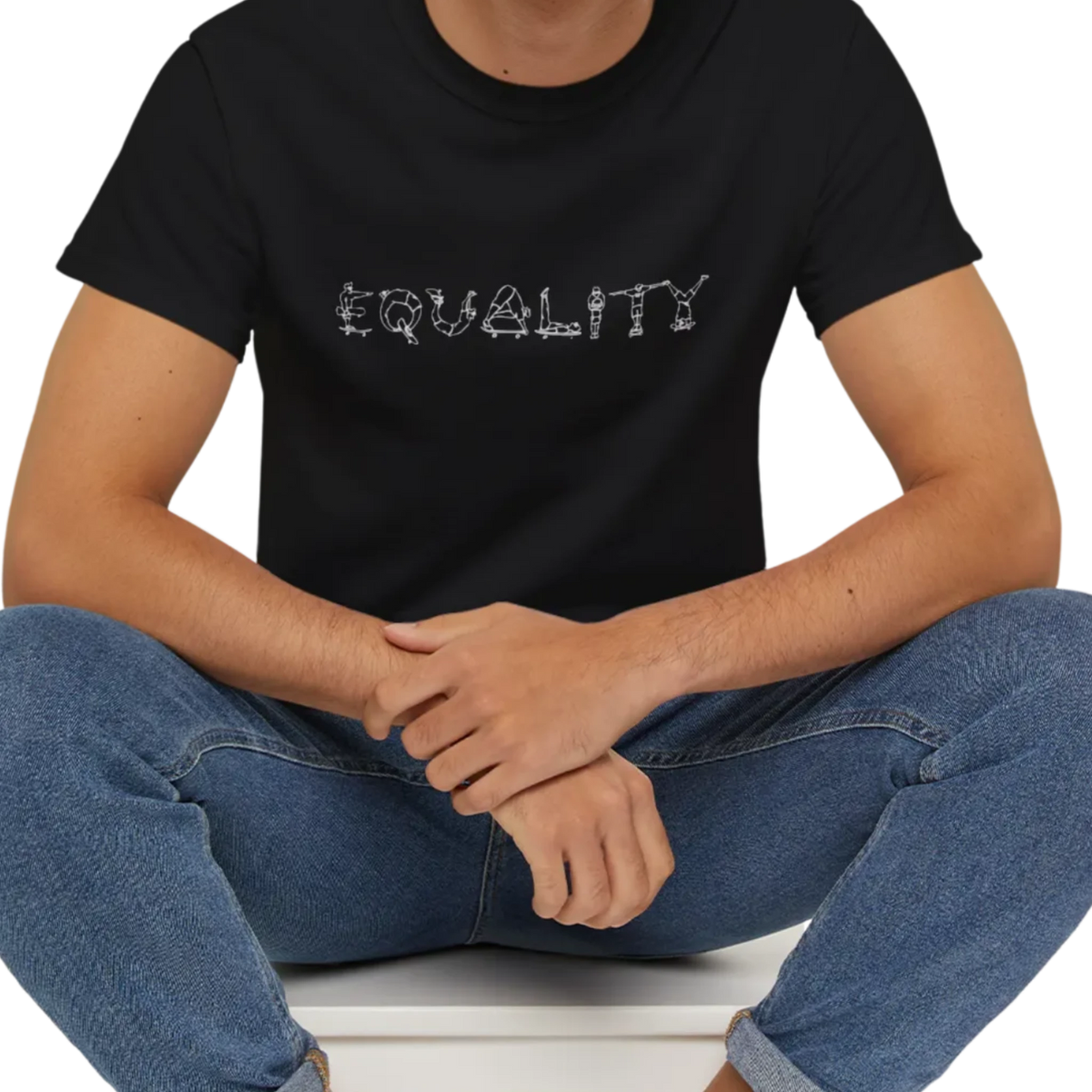 EQUALITY skater script graphic tee, black, front view on person, seated relaxed pose.