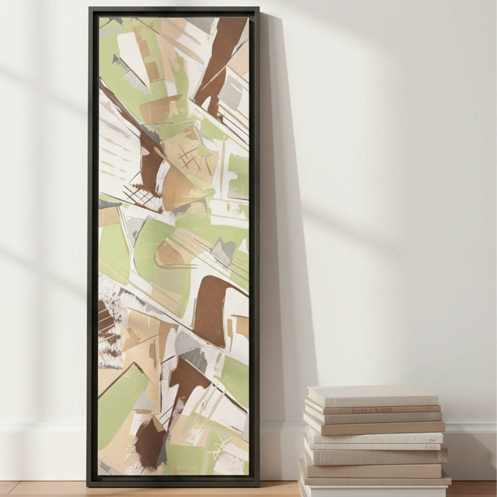 Espresso framed sage abstract canvas 12x36 leaning against wall on floor beside stacked coffee table books, scale reference.