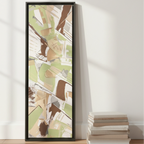 Espresso framed sage abstract canvas 12x36 leaning against wall on floor beside stacked coffee table books, scale reference.