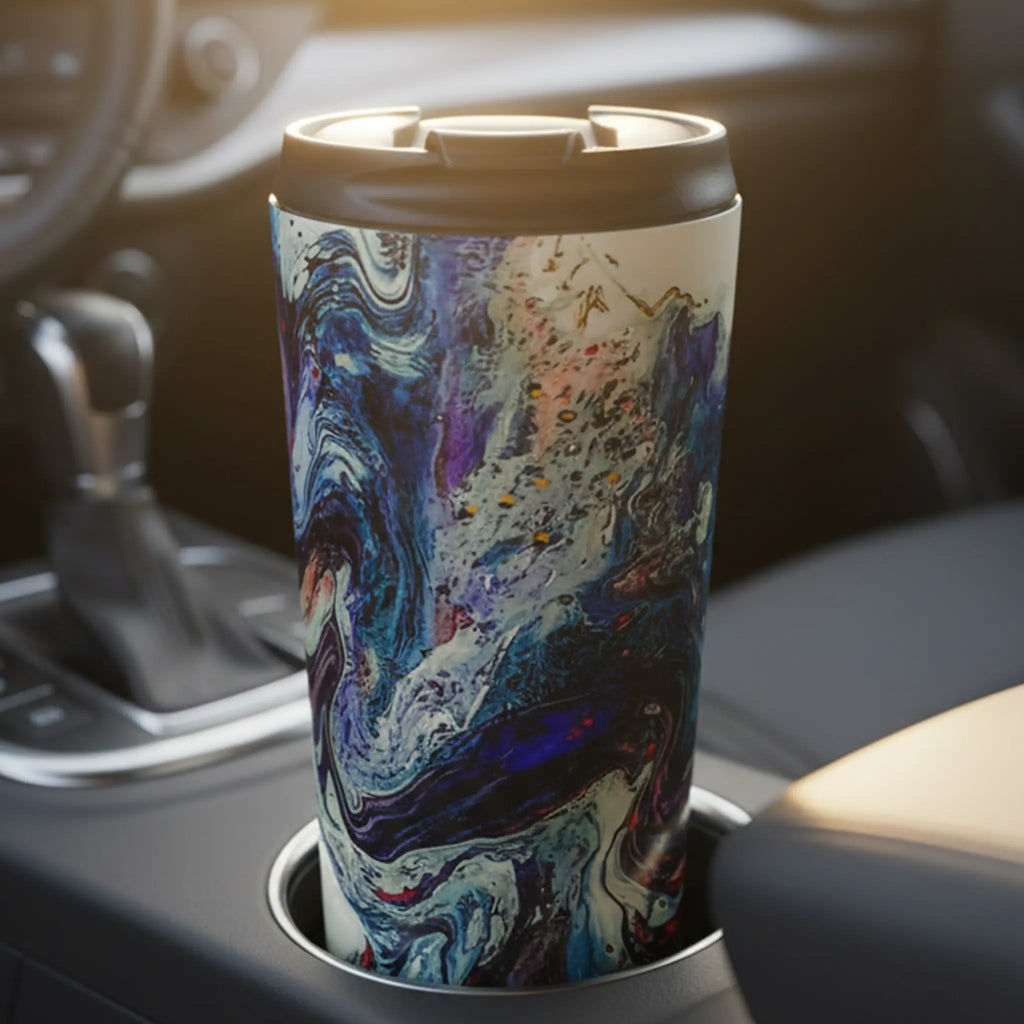 Freebrd Afrostar stainless steel travel mug in a car cupholder at sunrise showing vivid abstract acrylic pour artwork in navy, blue, white and red through the windshield morning light.