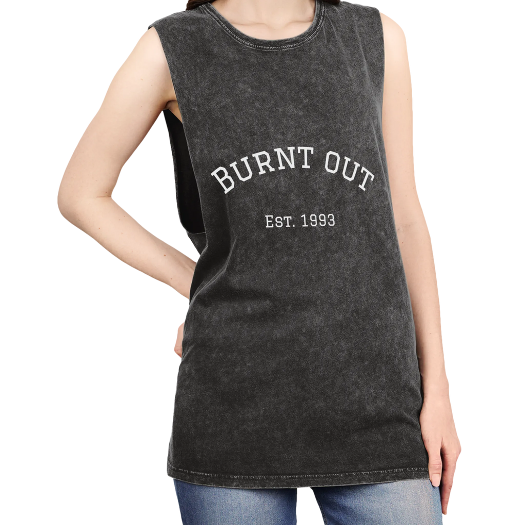 A person wearing the black stonewash personalized muscle tank with a white arched 'Burnt Out Est. 1993' graphic — custom birth year gift idea for him or her.