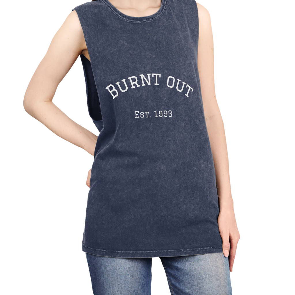 A person wearing the blue stonewash personalized muscle tank with a white arched 'Burnt Out Est. 1993' graphic — custom birth year gift idea for him or her.