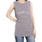 A person wearing the orchid stonewash personalized muscle tank with a white arched 'Burnt Out Est. 1993' graphic — custom birth year gift idea for him or her.