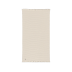 Parchment cotton waffle throw blanket laid flat, showing its textured surface and fringed ends.
