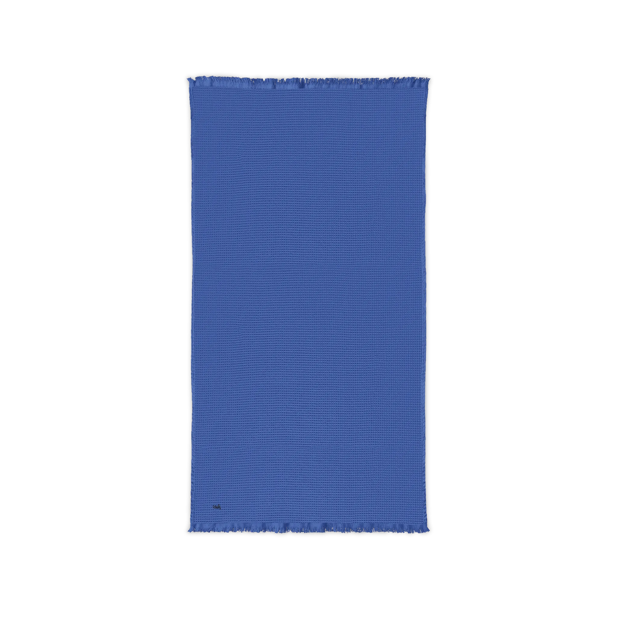Ultramarine blue cotton waffle throw blanket laid flat, showing its textured surface and fringed ends.