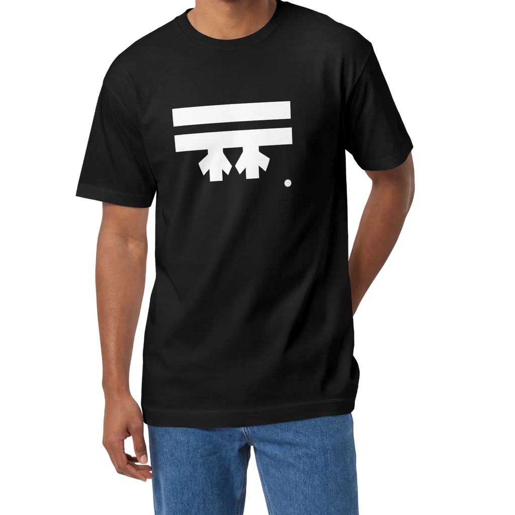 A man wearing a black FREEBRD Logo Classic T-Shirt, close-up showing the white FREEBRD logo on the chest.