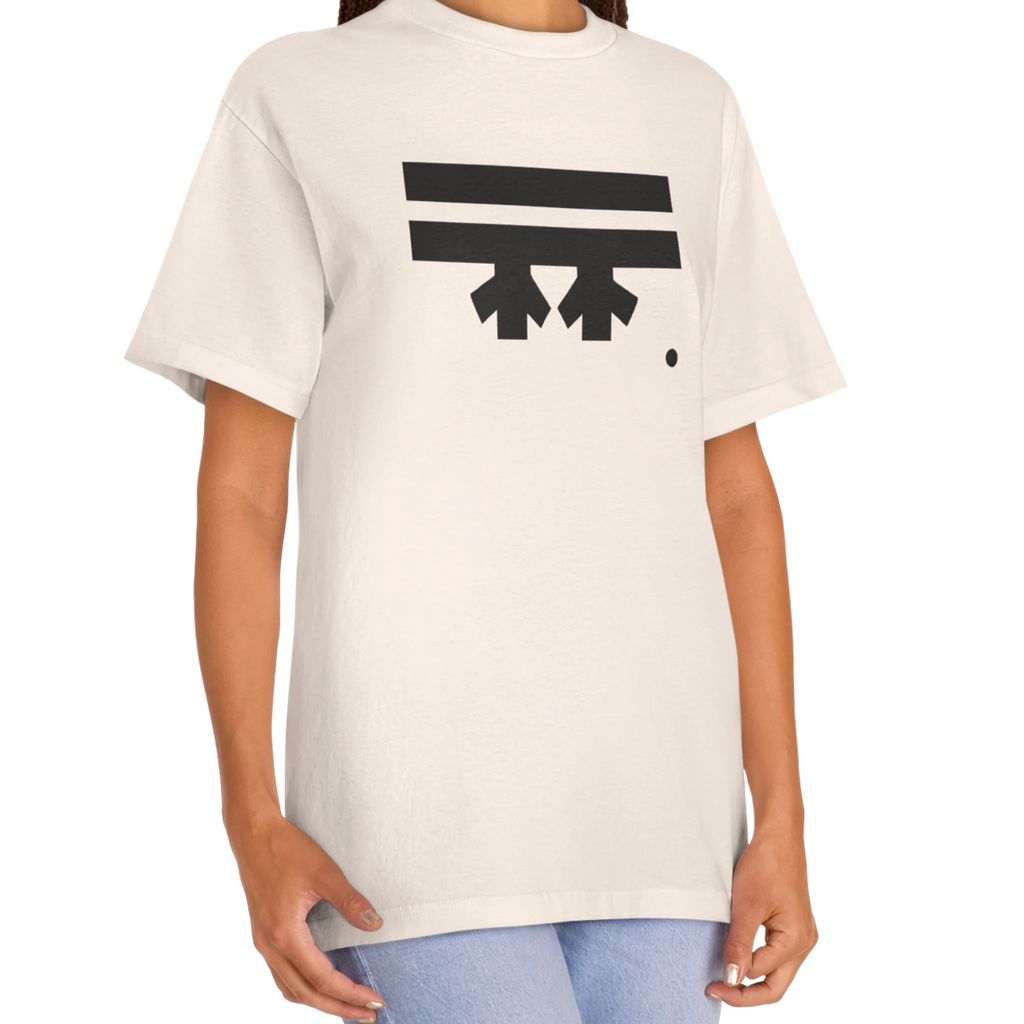 A woman wearing a cream FREEBRD Logo Classic T-Shirt, close-up showing the black FREEBRD logo on the chest.
