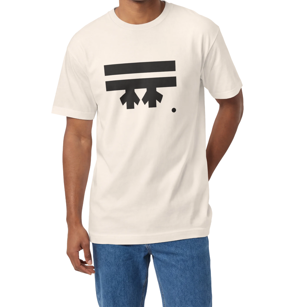 A man wearing a cream FREEBRD Logo Classic T-Shirt, close-up showing the black FREEBRD logo on the chest.