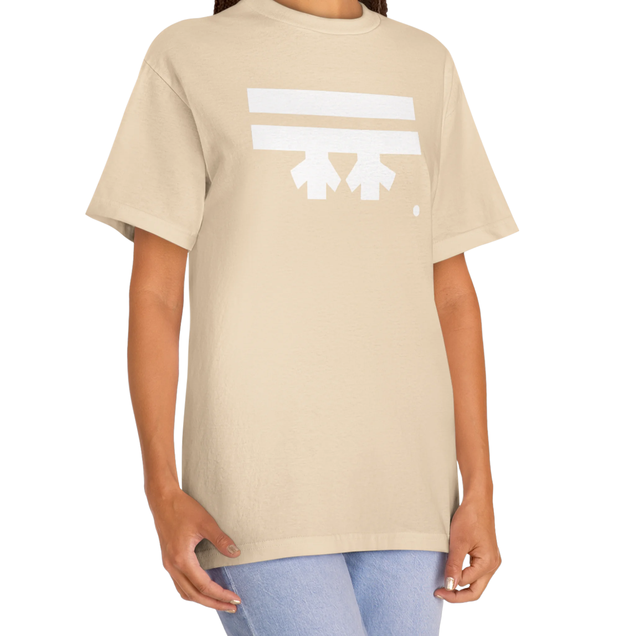 A woman wearing a sand FREEBRD Logo Classic T-Shirt, close-up showing the white FREEBRD logo on the chest.