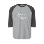 A Heather Grey/Heather Charcoal Unisex three-quarter Sleeve Baseball Raglan Tee with Heather Charcoal Sleeves on Heather Grey Shirt and "Love is Peace" in white text.