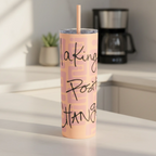 Freebrd Making Positive Changes peach blush skinny tumbler with black script text on a clean modern kitchen counter in soft natural morning light.
