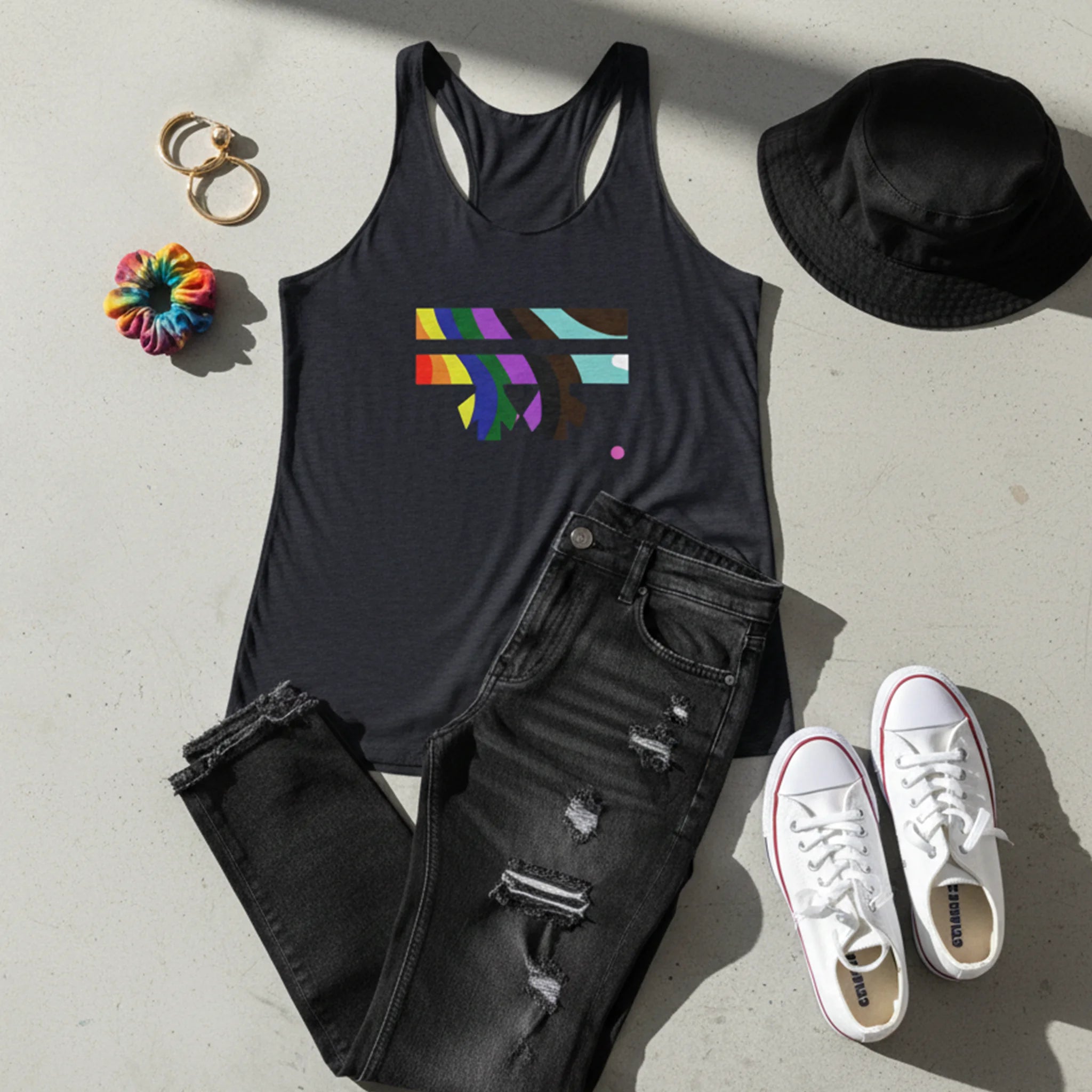 Vintage black FREEBRD rainbow wave racerback tank, styled flat lay with distressed denim, white sneakers, and bucket hat, streetwear aesthetic.