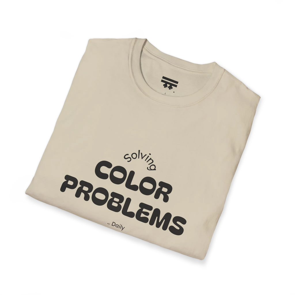 A folded preview of the sand t-shirt with 'solving color problems daily' black lettering text design on the front.