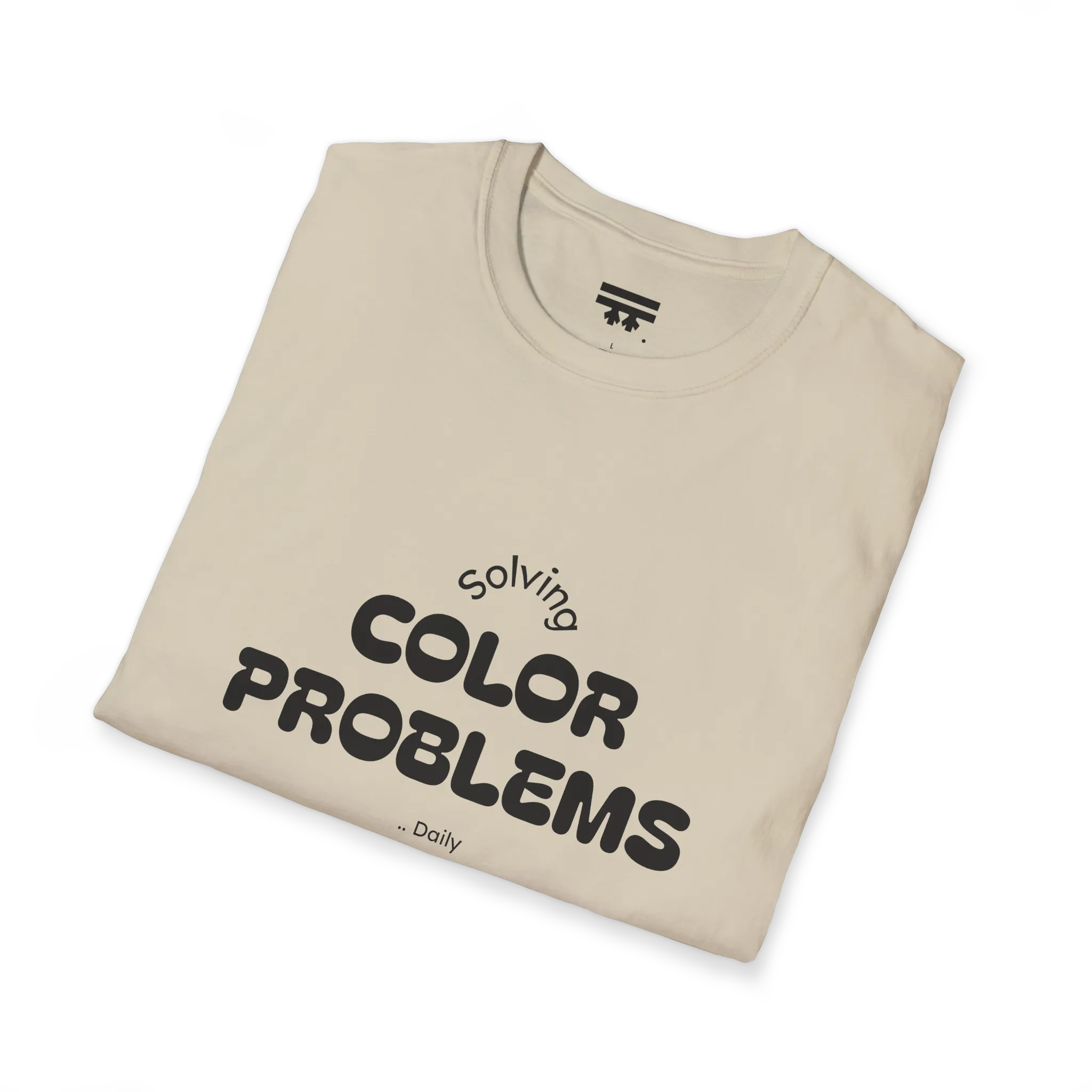 A folded preview of the sand t-shirt with 'solving color problems daily' black lettering text design on the front.