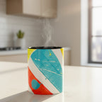 Freebrd Stripe Status coffee mug with bold teal red orange and yellow brushstroke design sitting on a modern urban apartment kitchen counter with warm morning light and steam rising from the cup.