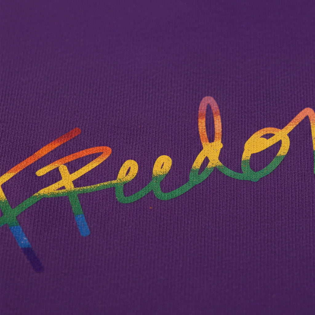 Freedom! Rainbow Script Premium T-Shirt, purple, rainbow script graphic detail, DTG print close-up, FREEBRD Pride Gear.