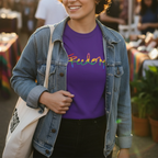 Freedom! Rainbow Script Premium T-Shirt, purple, layered denim jacket, outdoor weekend market,  lifestyle.