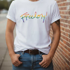 Freedom! Rainbow Script Premium T-Shirt, white, outdoor natural light, relaxed confident style,  lifestyle.