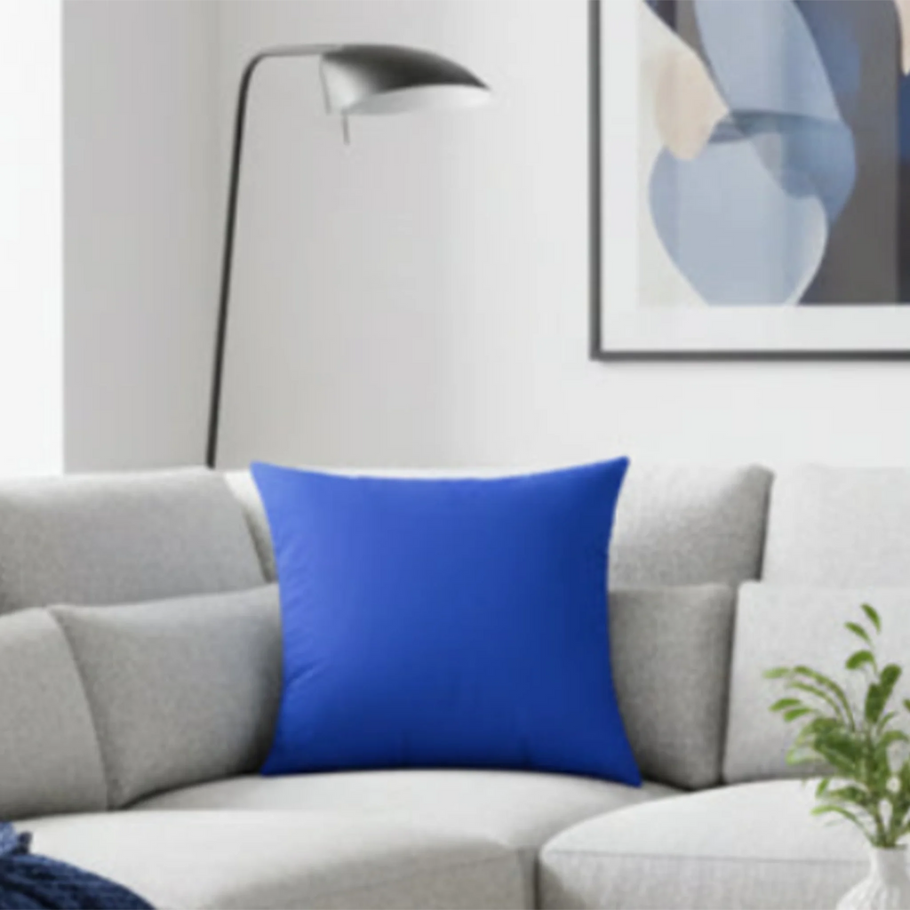 Funky blue faux suede pillow styled on sofa, bold cobalt blue home decor.
