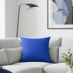 Funky blue faux suede pillow styled on sofa, bold cobalt blue home decor.