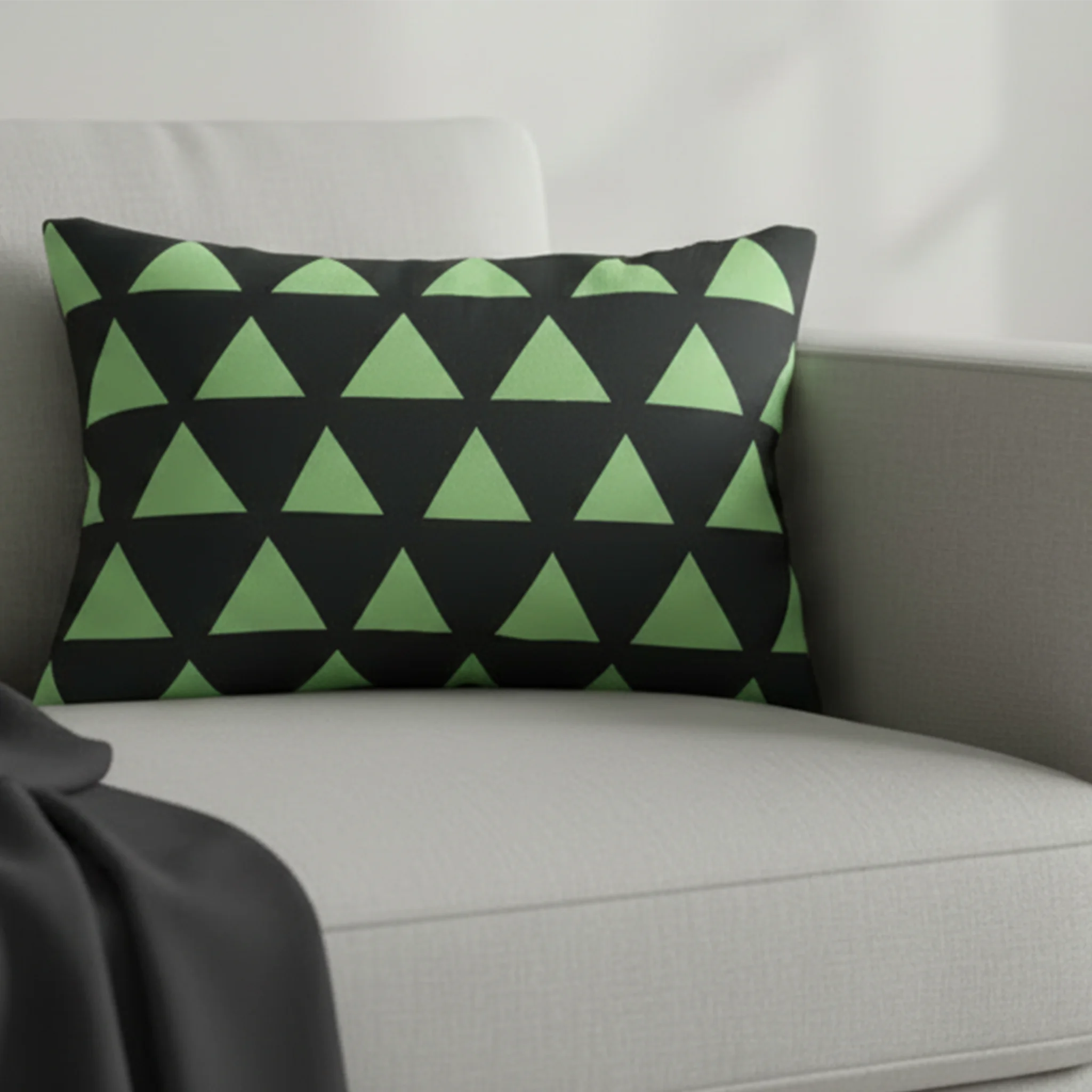 Geometric fresh green mint triangle lumbar pillow styled on a couch in a modern living room.