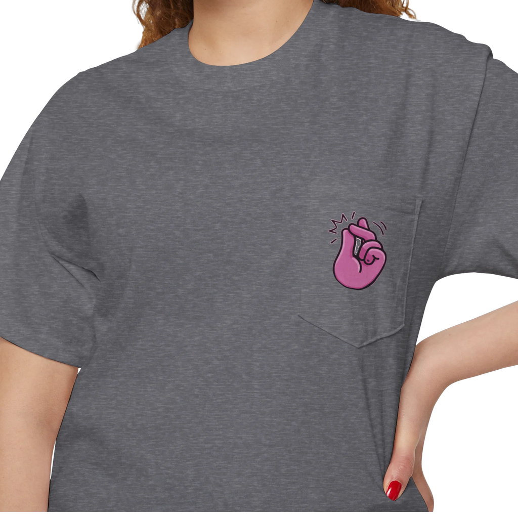 A person wearing a FREEBRD graphite heather classic cotton pocket t-shirt with a baby pink cartoon finger-snap Clock It graphic printed on the front chest pocket.