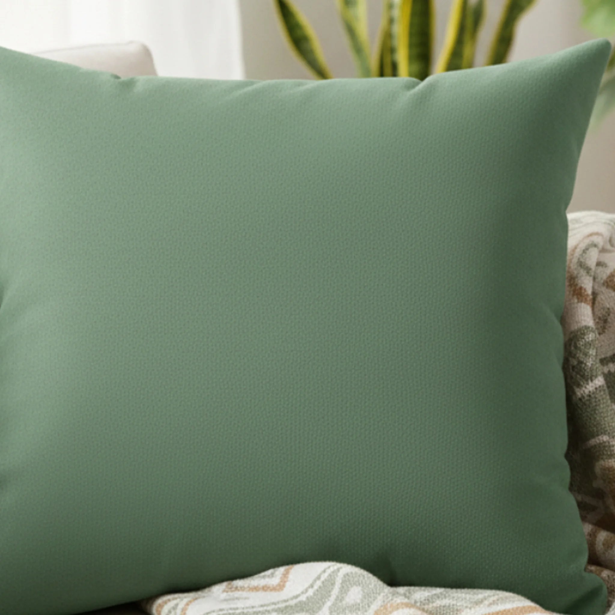 Green dust faux suede pillow, styled on a couch lifestyle view. 