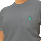 A grey pocket t-shirt with a sea green Clock It Motif on front left chest pocket shown up close.